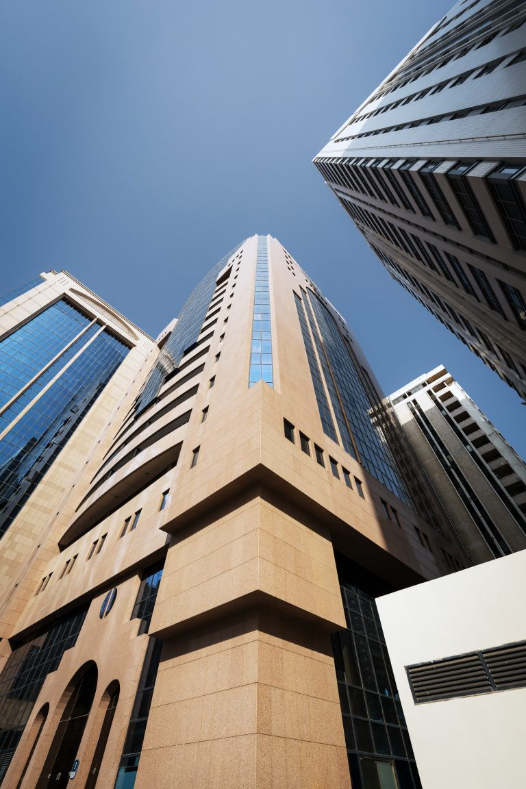 Exterior view of Al Salam Tower in Abu Dhabi in sunrise light.